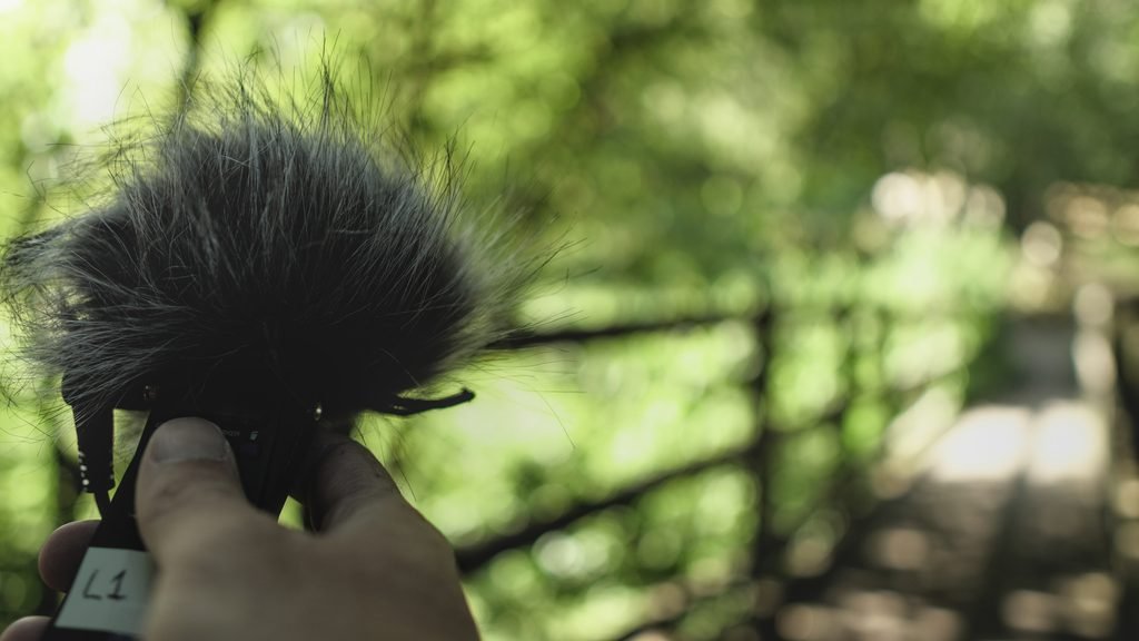 A participant using a handheld recorder in Burrs Country Park.
